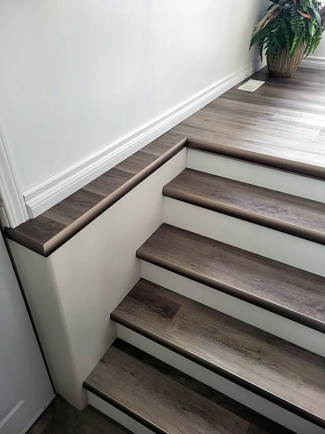 Stair landing with plank flooring and matching stair nosing