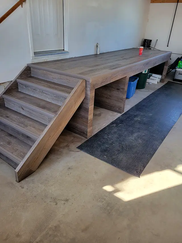 Custom platform and steps wrapped in plank flooring