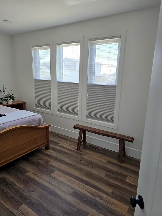 Bedroom with three windows fitted with cellular shades